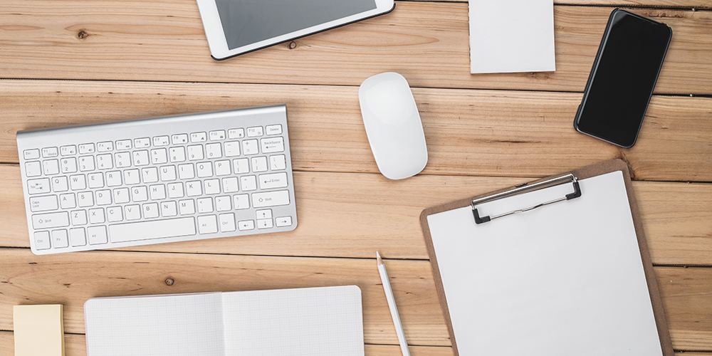 Top View of desk with stationery, coffe and digital product